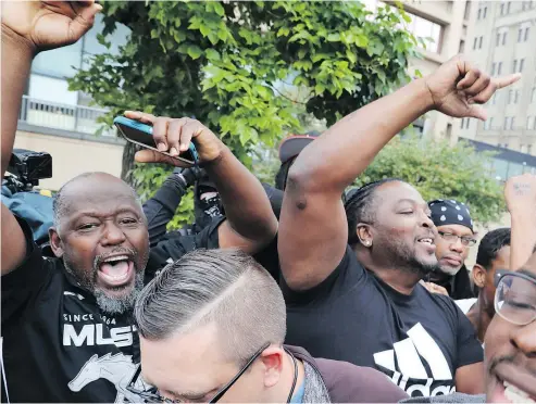  ?? — AP PHOTO ?? Protesters cheer in front of the courthouse after a mostly white jury found white Chicago police officer Jason Van Dyke guilty of second-degree murder in the 2014 shooting of black teenager Laquan McDonald.