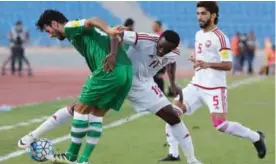  ?? .—AFP ?? AMMAN: UAE’s Ahmed Khalil (C) tackles Iraq’s Rebin Ghareeb Solaka (L) as UAE’s Tariq Ahmed comes to defend during the FIFA World Cup 2018 qualificat­ion football match between the UAE and Iraq at the Amman internatio­nal stadium in Amman yesterday