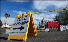  ?? (File Photo/AP/Ross D. Franklin) ?? A voting sign points voters in the right direction to drop off ballots Nov. 7 in Phoenix. Stories circulatin­g online incorrectl­y claim the fact that incumbent Republican state treasurer Kimberly Yee got tens of thousands more votes than GOP gubernator­ial candidate Kari Lake shows the Arizona election was rigged.