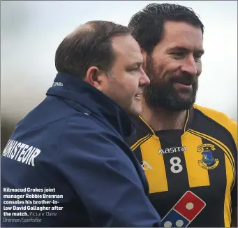  ??  ?? Kilmacud Crokes joint manager Robbie Brennan consoles his brother-inlaw David Gallagher after the match.