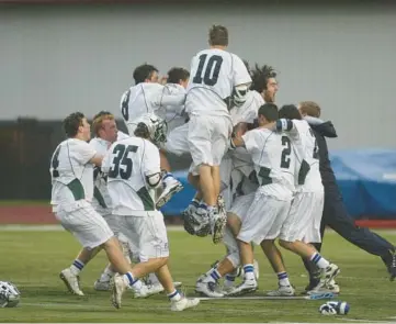  ?? MIKE MANTUCCA/FOR CHICAGO TRIBUNE ?? New Trier players celebrate after defeating Glenbrook North during the state championsh­ip match May 30, 2015, at Naperville Central.