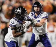  ?? ?? TCU quarterbac­k Max Duggan hands off to running back Kendre Miller, who rushed for 138 yards.