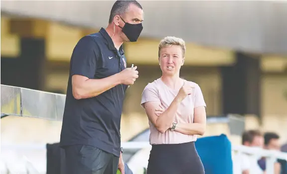  ?? GERARD FRANCO/CANADA SOCCER FILES ?? Bev Priestman, right, speaks to assistant Michael Norris during a game in Spain on June 11. Priestman says the team is capable of going for the gold.