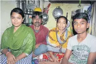  ??  ?? Khokun Hamid, his wife Ayesha (second from right), daughter Nazma and son Alamin live in a single room in a slum in South Delhi.