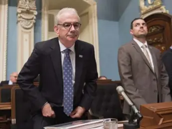  ?? JACQUES BOISSINOT/THE CANADIAN PRESS ?? Commission­er Robert Lafrenière prepares to testify Thursday at a legislatur­e committee on public security.