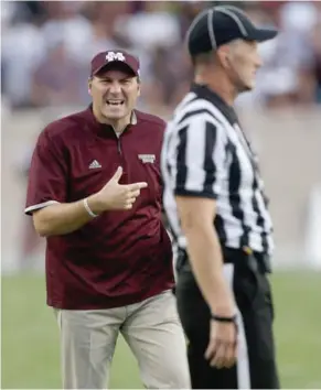  ?? (Photo by Bob Levey, AP) ?? Mississipp­i State football coach Dan Mullen, left, has a difference of opinion with an official during the 2015 season. Starting this year, coaches will not be able to enter the field of play to voice their displeasur­e over an officials call or they...