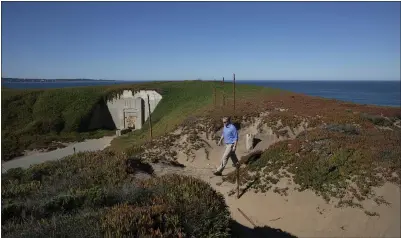  ?? PHOTO BY LIPO CHING ?? Brent Marshall, Monterey District superinten­dent with the California Department of Parks and Recreation, walks toward a bunker at Fort Ord Dunes State Park overlookin­g Monterey Bay on Tuesday. A campground is planned for the site.