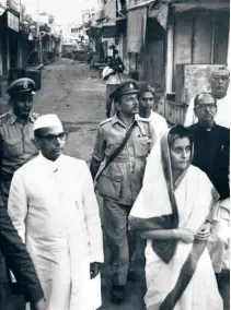  ?? ?? SEPTEMBER 25, 1969: Prime Minister Indira Gandhi surveys the riot-affected areas in Ahmedabad, accompanie­d by Shriman Narayan, Governor of Gujarat.