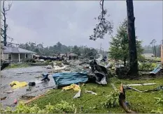  ?? Alicia Jossey / Via AP ?? Debris covers the street in East Brewton, Ala., on Saturday. Authoritie­s say a suspected tornado spurred by a tropical storm demolished or badly damaged at least 50 homes.