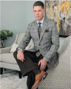  ?? PHOTO: ELAINE MARK/ D&M IMAGES ?? MIX IT UP ON OUR COVER – Ryan Walter with Elwood Flynn Ltd. defines business class in this handsome blue-grey glen plaid two-button sport coat with side vents, superbly tailored from Italian Merino wool by Canadian menswear leader Warren K. Cook. For the office, Ryan teams the jacket with espresso brown pants by Coppley and a soft blue Lipson pure cotton dress shirt. Accessorie­s include a Hugo Boss tie, Italian silk pocket hanky by Dion and cognac brown shoes by Allen Edmonds. After hours, Ryan pairs the sport coat with a black knit turtleneck and jeans, also from Elwood Flynn, located downtown at 200 Third Avenue South.Ryan’s hair cut and styled by Aziz Pulas at JR’s Barber Stylists on Central Avenue.