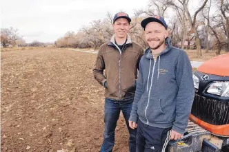  ?? JIM THOMPSON/JOURNAL ?? Elan Silverblat­t-Buser, left, and his brother Aaron, owners of Corrales’ Silver Leaf Farms, grow vegetables in this field near Toad Road in the village. The brothers lease the property from a landowner who sold the conservati­on easements on the land in...