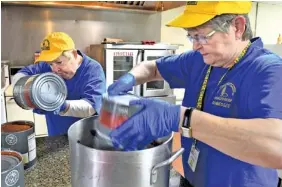  ?? MICHAEL PATRICK/NEWS SENTINEL ?? Tennessee Baptist Disaster Relief crew members Linda Wade, left, and Janie Fairchild cook meals for as many as 1,000 volunteers working at homes and churches with chainsaws and rakes during the wildfire cleanup efforts Tuesday.