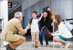  ?? REBEKAH WELCH — THE SEATTLE TIMES VIA ASSOCIATED PRESS FILE ?? On July 14, Jelsin Aguilar Padilla shakes immigratio­n attorney Jorge L. Baron’s hand after stepping off his flight from New York into the Seattle-Tacoma Internatio­nal Airport as he is reunited with his mother, Yolany, in Seattle.