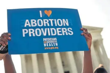  ?? Mandel Ngan, Afp/getty Images ?? Abortion rights activists hold placards outside of the U.S. Supreme Court ahead of an expected ruling in 2016 on abortion clinic restrictio­ns in Washington, D.C.