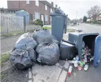  ??  ?? > Bins were pile high as collection­s were missed