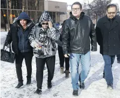  ?? JOHN WOODS / THE CANADIAN PRESS ?? Thelma Favel, second from left, Tina Fontaine’s aunt and the woman who raised her, leaves court with unidentifi­ed family members and supporters Wednesday.