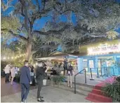  ?? PHELAN M. EBENHACK/ORLANDO SEN/ORLANDO SENTINEL ?? Attendees sample the food and drink offerings from vendors during the opening night of the Florida Film Festival at the Enzian Theater, April 12, 2019, in Maitland.