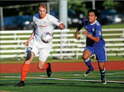  ?? PHOTOS BY TANIA BARRICKLO — DAILY FREEMAN ?? Kingston Stockade FC’s Eric Fortier, left, goes in for one of his two goals during Monday’s game against TSF Academy FC at Dietz Stadium on Monday night.