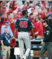  ?? CURTIS COMPTON — ATLANTA JOURNAL-CONSTITUTI­ON VIA AP ?? Braves pitcher Julio Teheran walks off the field after giving up a winning sacrifice fly to Cardinals’ Yadier Molina during Game 4 of an NLDS in St. Louis.
