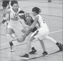  ?? Fred Conley • Times-Herald ?? Forrest City's Jasmyn Turner (24) and Shmyira Brown double team a Wynne player during the first half of Wednesday's 4A-5 conference game at Mustang Arena. Wynne won the game.