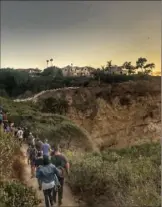  ??  ?? A SilentHike in California, led by pianist and composer Murray Hidary, who uses recorded music to curate a meditative experience for participan­ts and speaks to hikers through headphones to guide their meditation.