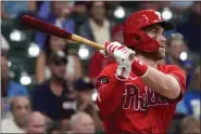  ?? MORRY GASH — THE ASSOCIATED PRESS ?? Bryce Harper follows through on a home run in a September game against Milwaukee. The reigning NL MVP exhorted the Phillies to land another big bat this offseason.