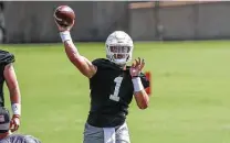  ?? Aaron E. Martinez / Associated Press ?? Texas quarterbac­k Hudson Card throws in a recent practice as he and Casey Thompson compete for the starting job.