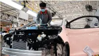  ?? XINHUA PHOTO ?? A worker on the production line of new energy vehicles at a factory of Chinese automaker Chery Holding Group Co. Ltd. in the city of Wuhu, Anhui province, eastern China on Oct. 12, 2022.