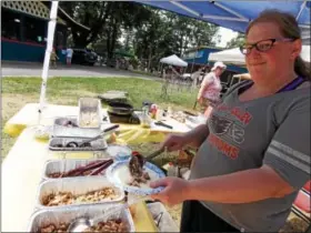  ?? LISA MITCHELL - DIGITAL FIRST MEDIA ?? NomFest at Kutztown Park raised funds for the poor and homeless on July 23. Kutztown resident Julia Zion, who founded Nom Prophets, served tacos at NomFest.