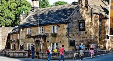  ??  ?? RELAXED: The pub in the village of Beeley. Top: A bedroom designed by the Duchess of Devonshire