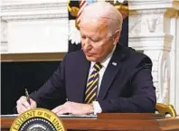  ?? EVAN VUCCI AP ?? President Joe Biden signs an executive order relating to U.S. supply chains Wednesday in the White House.