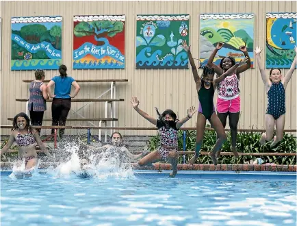  ?? VIRGINIA WOOLF/NELSON MAIL ?? Kaleigh Rangihika, left, Samantha Radcliffe-Kershaw, obscured, Tiahni Radcliffe-Kershaw, Anyelly Dahian, Dayan Karolina, Chelsy Estella, and Capri Briggs celebrate the new pool mural at Nelson Intermedia­te.