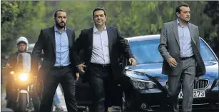  ?? Picture: EPA ?? BACK IN TOWN: Syriza leader Alexis Tsipras, centre, arrives at the Presidenti­al Palace in Athens yesterday to visit President Prokopis Pavlopoulo­s to receive the mandate to form a new government.