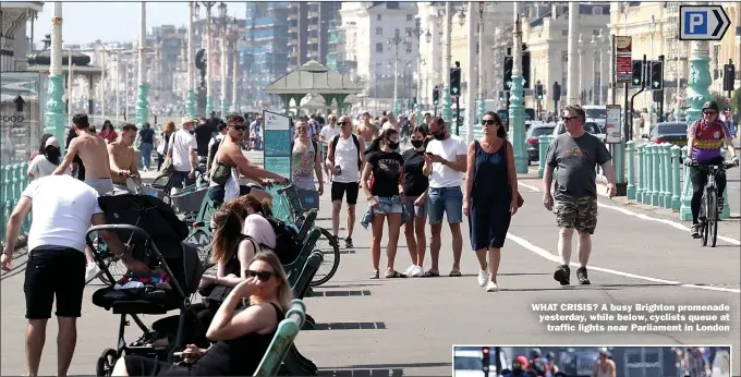  ??  ?? WHAT CRISIS? A busy Brighton promenade yesterday, while below, cyclists queue at traffic lights near Parliament in London