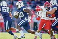  ?? Bryan Woolston / Associated Press ?? UConn’s Robert Burns runs with the ball during the first half against Liberty.