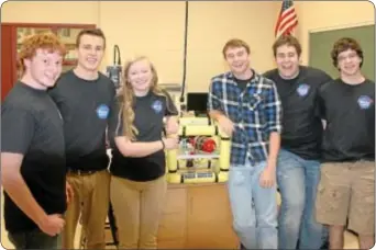  ?? Photos by Cary Beavers ?? Part of Council Rock South’s Rock Rovers team, from left, juniors Brian Butler, Eric Quidort and Kat Johnston, seniors Jared Sobel and Tommy Hinchliffe and junior Matthew Piorko proudly display their Remotely Operated Vehicle (ROV). The ROV was...