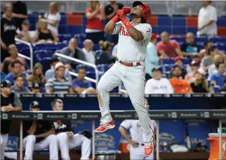  ?? The Associated Press ?? Philadelph­ia Phillies’ Maikel Franco leaps into the air as he heads for home after hitting a home run during the eighth inning against the Miami Marlins on Tuesday. Franco had three hits, including the tie-breaking home run in the eighth.