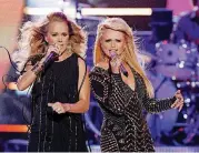  ?? AP FILE] [PHOTO BY WADE PAYNE, INVISION/ ?? Carrie Underwood, left, and Miranda Lambert perform at the 2014 CMT Music Awards.