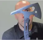  ?? JON R. ANDERSON ?? Brensinger shows off the new Point Man Ax, one of two multitool hatchets that have just been released.