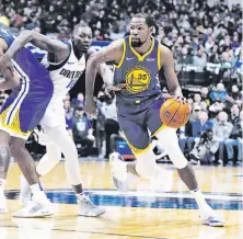 ?? Richard W. Rodriguez / Associated Press ?? Warriors forward Kevin Durant, who scored 28 points, drives past Dorian Finney-Smith in the first half Sunday night.