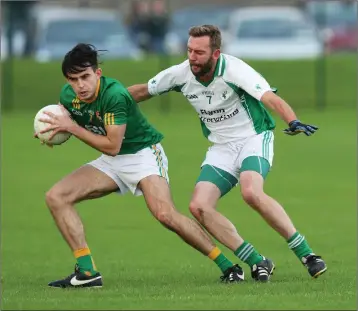  ??  ?? Dunlavin’s Alan O’Sullivan looks to get clear of Donard-The Glen’s Bill Flynn. Photo: Joe Byrne