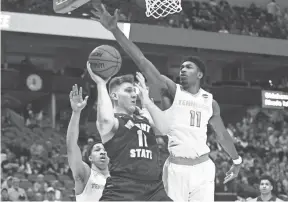  ??  ?? Tennessee forward Kyle Alexander blocks Wright State center Loudon Love during the NCAA Tournament game on Thursday. BRIANNA PACIORKA/NEWS SENTINEL