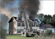  ?? TOM KELLY III — FOR DIGITAL FIRST MEDIA ?? A large two-story home was destroyed by fire Thursday morning along with several out buildings and garages in the 500 block of Congo Road in the Gilbertsvi­lle section of Douglass Township.