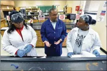  ?? HYOSUB SHIN / HSHIN@AJC.COM ?? Dr. Randall Harris, assistant professor of chemistry, helps students at Claflin University. Claflin has a proud and enduring legacy of producing visionary leaders.