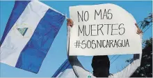  ?? ALFREDO ZUNIGA THE ASSOCIATED PRESS ?? A demonstrat­or holds a sign with a message that reads in Spanish, “No more deaths,” in Managua, Nicaragua, Monday.