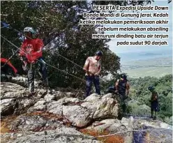  ??  ?? PESERTA Expedisi Upside Down Bonda Mandi di Gunung Jerai, Kedah ketika melakukan pemeriksaa­n akhir sebelum melakukan abseiling menuruni dinding batu air terjun pada sudut 90 darjah.