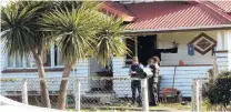  ?? PHOTO: RICHARD DAVISON ?? Inquiries ongoing . . . A uniformed police officer questions an Owaka resident at the site of an armed offenders squad callout at lunchtime yesterday.