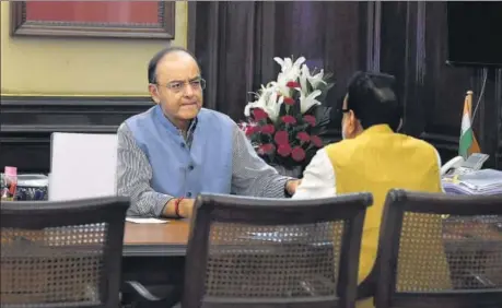  ?? PTI ?? Finance minister Arun Jaitley with revenue secretary Hasmukh Adhia at his office in North Block, New Delhi, on Thursday.