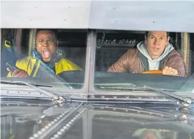  ??  ?? Winston Duke and Mark Wahlberg in “Spenser Confidenti­al.”