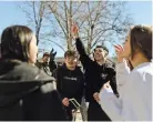  ?? JESSE BARBER FOR THE NEW YORK TIMES ?? Students at Asbury University in Kentucky singing worship songs outside of Hughes Chapel last month.